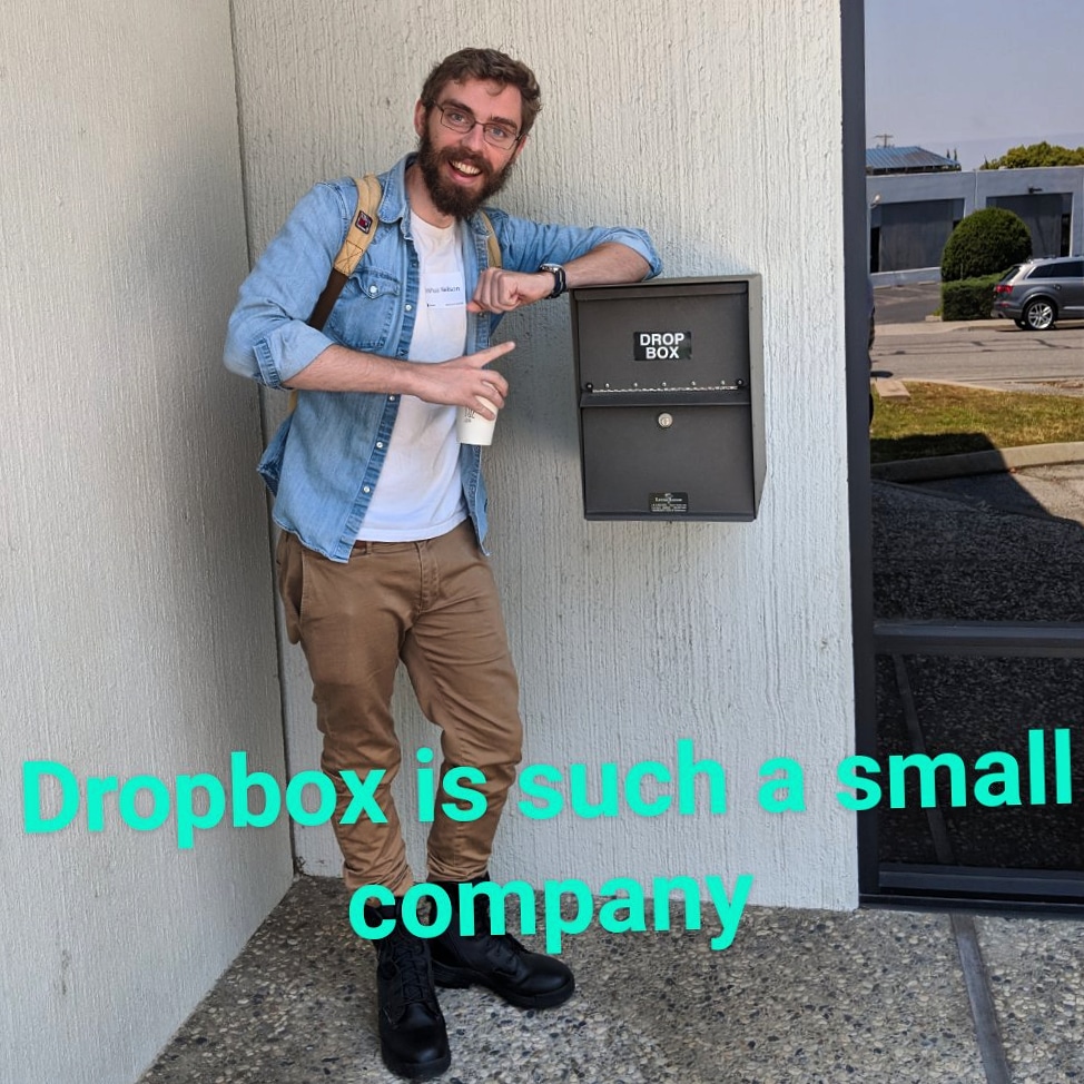 my friend next to a letter box that says 'drop box'